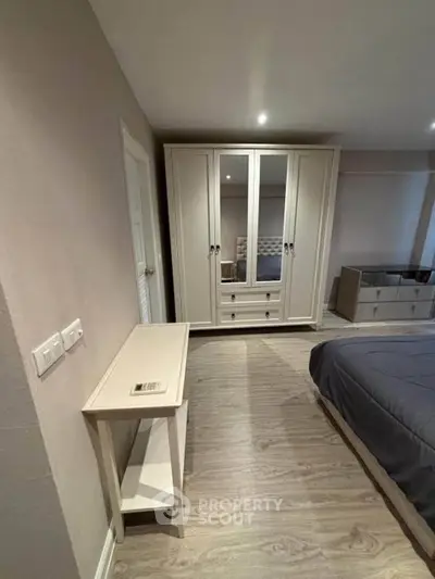 Spacious bedroom with elegant wardrobe and modern decor