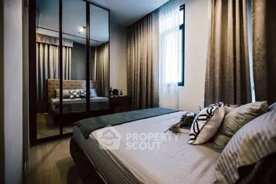 Cozy modern bedroom with stylish decor and mirrored wardrobe