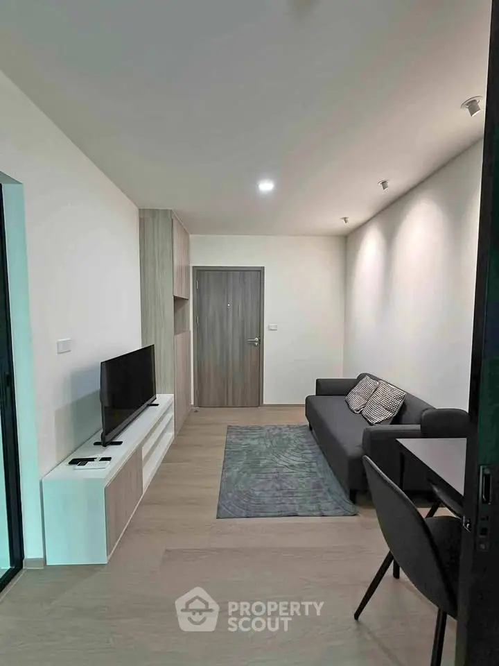 Modern living room with sleek furniture and stylish decor in a contemporary apartment.