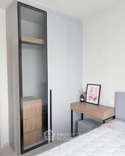 Modern bedroom with sleek wardrobe and stylish desk, perfect for contemporary living.