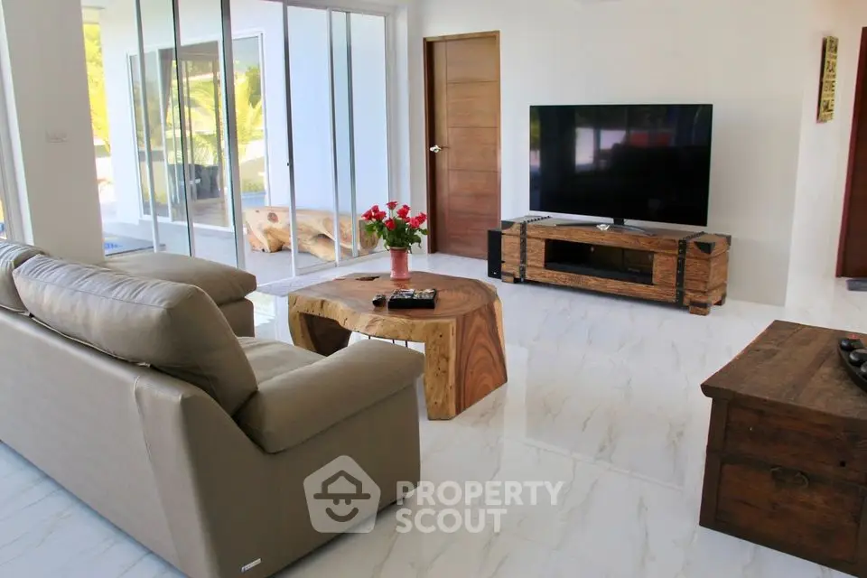 Spacious modern living room with large TV and stylish wooden furniture