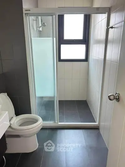 Modern bathroom with sleek shower and contemporary fixtures in a stylish apartment.