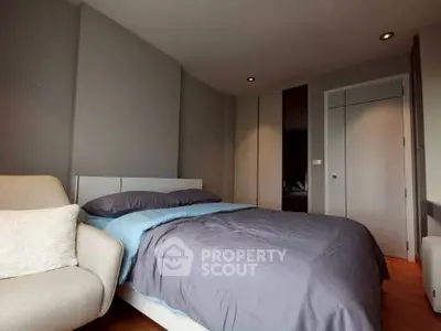 Modern bedroom with cozy bed and stylish decor in a contemporary apartment.