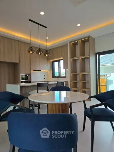 Modern kitchen with sleek design, featuring open layout and stylish lighting, perfect for contemporary living.