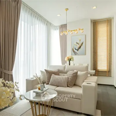 Elegant living room with modern decor and natural light, featuring plush sofa and chic lighting.