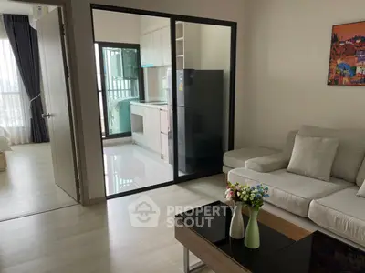 Modern living room with open kitchen and balcony view