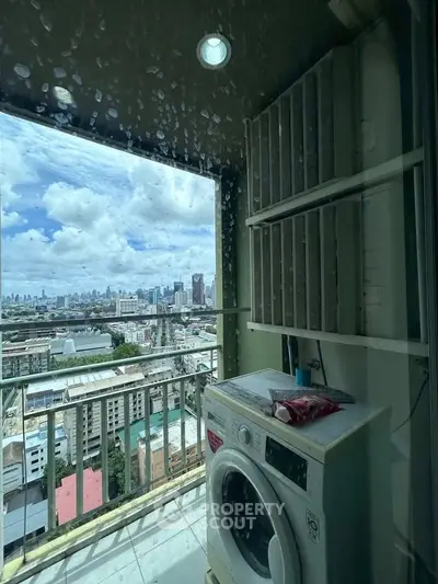 High-rise apartment balcony with washing machine and stunning city skyline view.