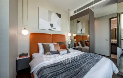 Luxurious modern bedroom with stylish decor and cozy ambiance.