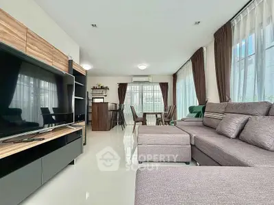 Spacious modern living room with sleek furniture and large windows.