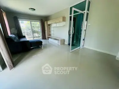 Spacious living room with modern sofa and large windows for natural light