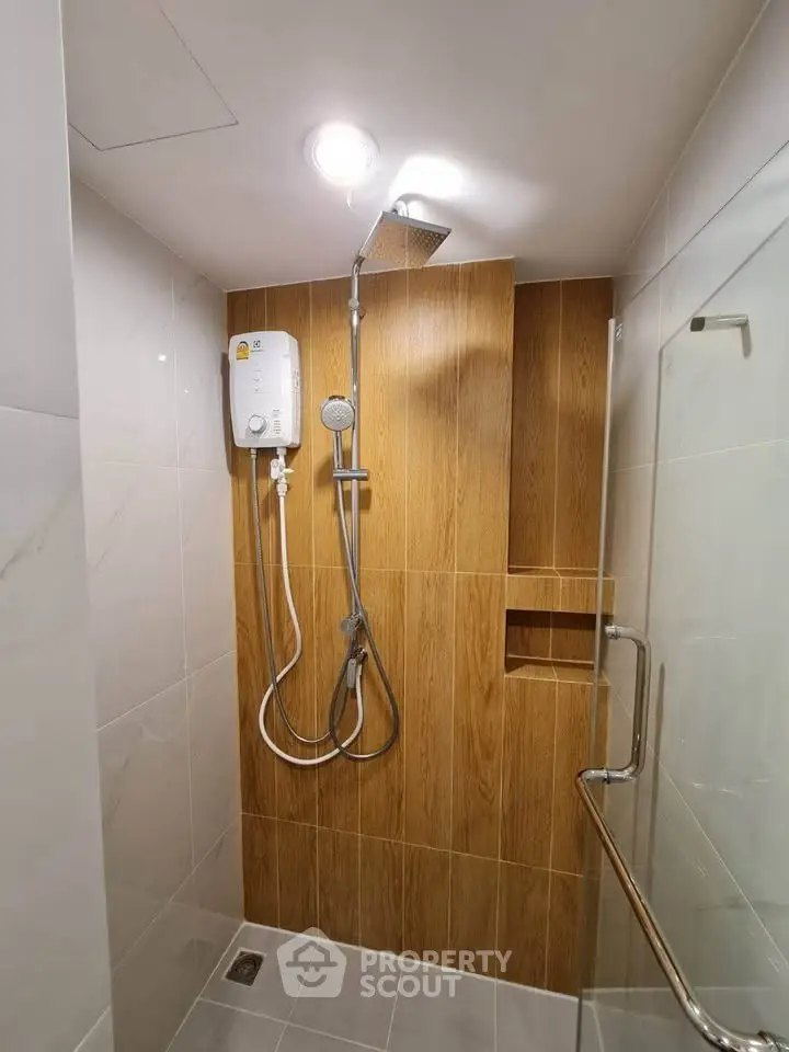 Modern bathroom with sleek shower and wood accent wall
