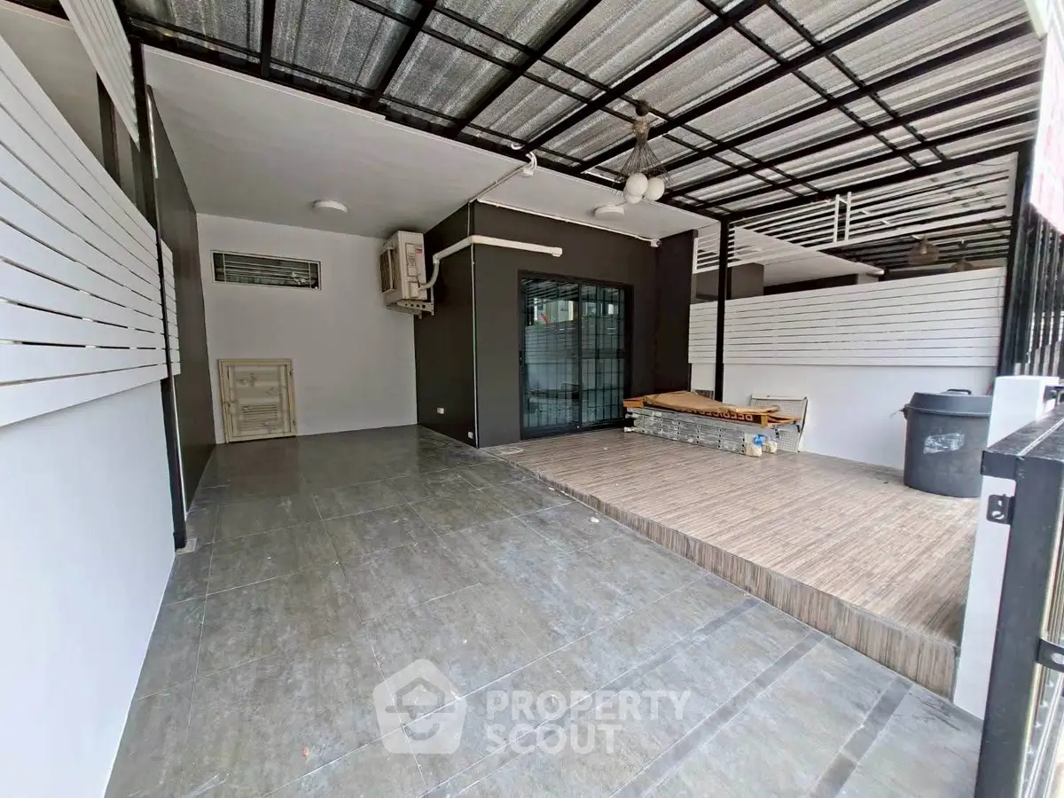 Spacious covered outdoor area with modern design and tiled flooring