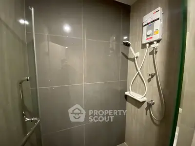 Modern bathroom with sleek shower and water heater in stylish apartment.