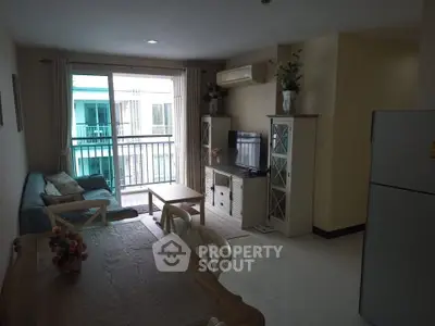 Charming living room with balcony view, cozy seating, and modern decor in a stylish apartment.