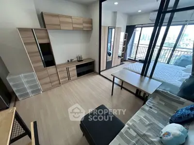 Modern studio apartment with open layout and city view balcony