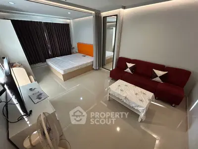 Modern studio apartment with sleek design, featuring a cozy bed, stylish sofa, and elegant decor.