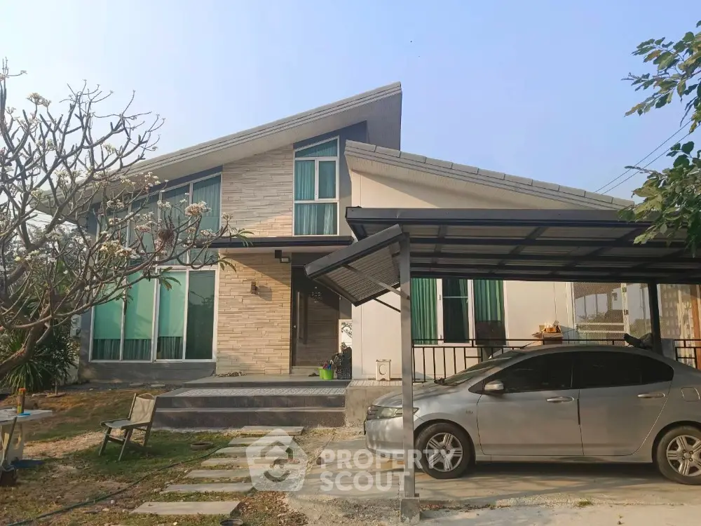Modern single-story house with carport and landscaped garden