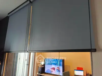 Modern living room with sleek roller blinds and entertainment setup