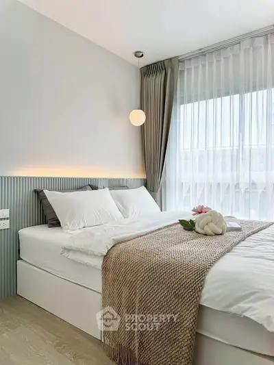 Elegant bedroom with modern decor, featuring a cozy bed and soft lighting, perfect for relaxation.