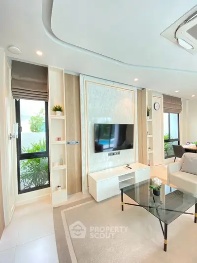 Modern living room with elegant decor and large windows offering natural light
