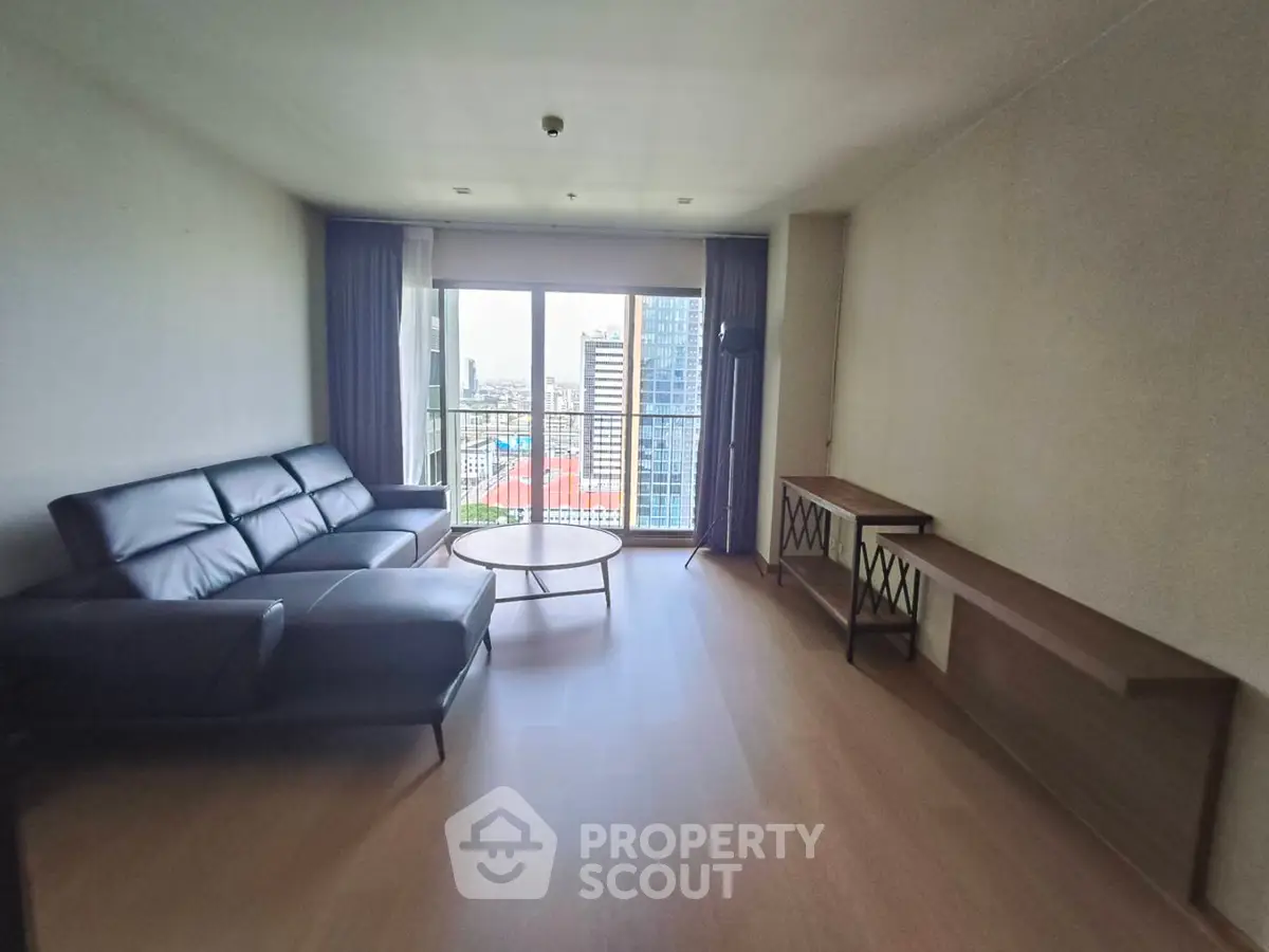 Spacious living room with modern furniture and city view balcony