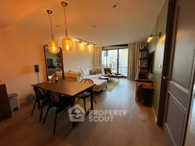Spacious modern living room with city view, elegant lighting, and cozy seating area.