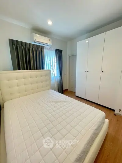 Cozy bedroom with modern white furniture and natural light