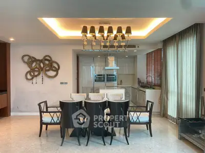 Elegant dining area with modern chandelier and open kitchen layout