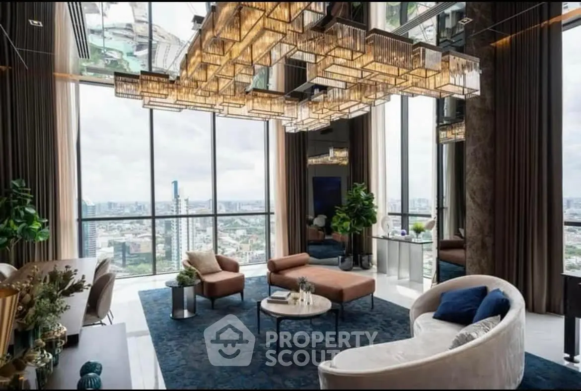 Luxurious high-rise living room with panoramic city views and elegant chandelier.