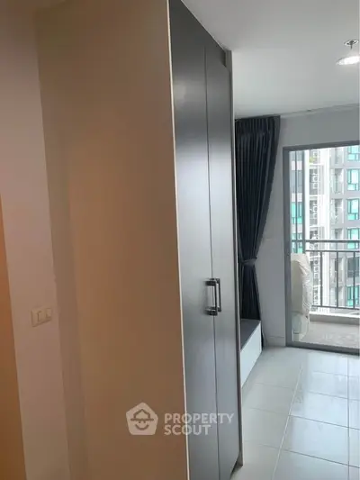Modern apartment interior with sleek wardrobe and balcony view