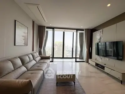 Spacious modern living room with panoramic city view and elegant decor.