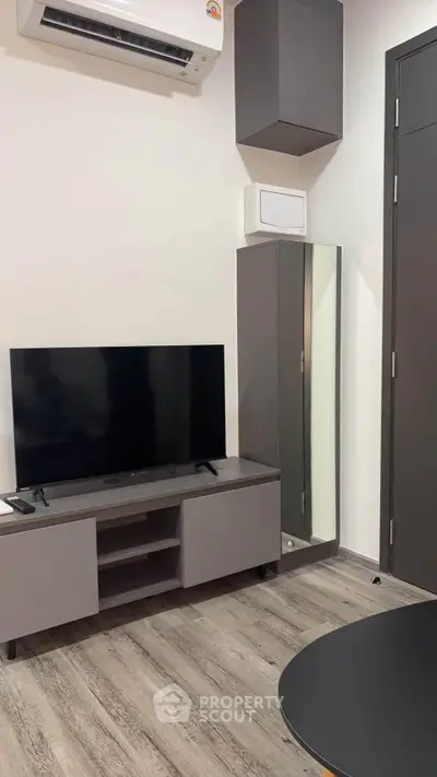 Modern living room with sleek TV setup and stylish cabinetry