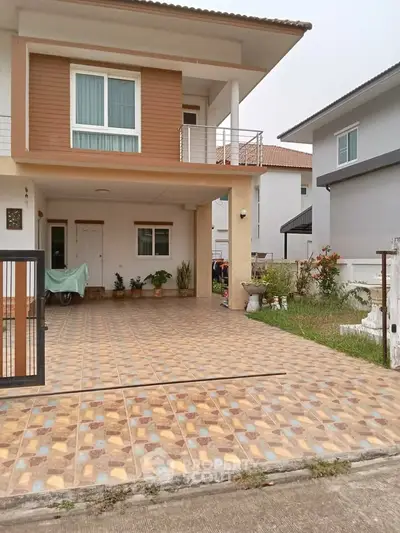 Charming two-story house with spacious tiled driveway and balcony in a serene neighborhood.