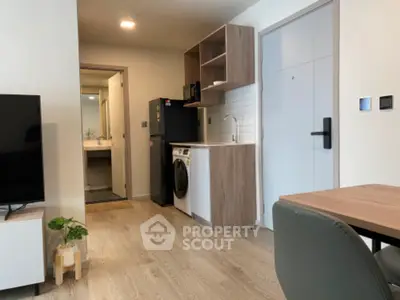 Modern apartment interior with compact kitchen and washing machine
