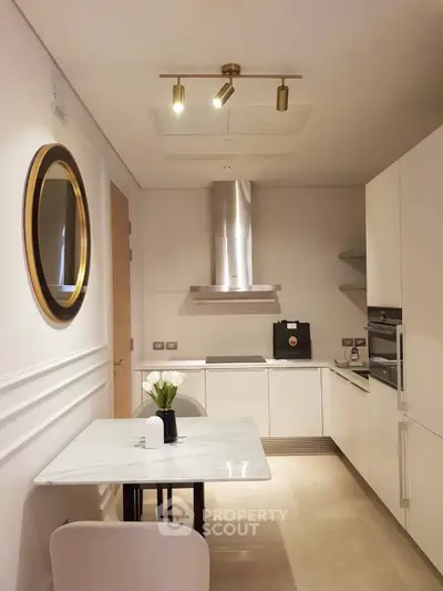 Modern kitchen with sleek white cabinets and marble dining table