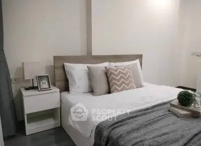 Cozy bedroom with modern decor and stylish bedding in a contemporary apartment.