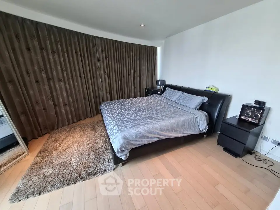 Spacious bedroom with elegant decor and large window
