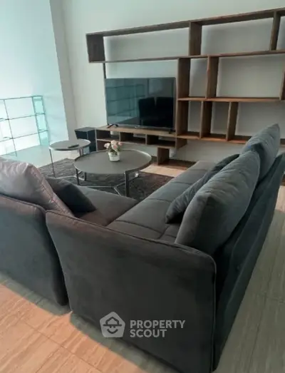 Modern living room with sleek furniture and large TV setup