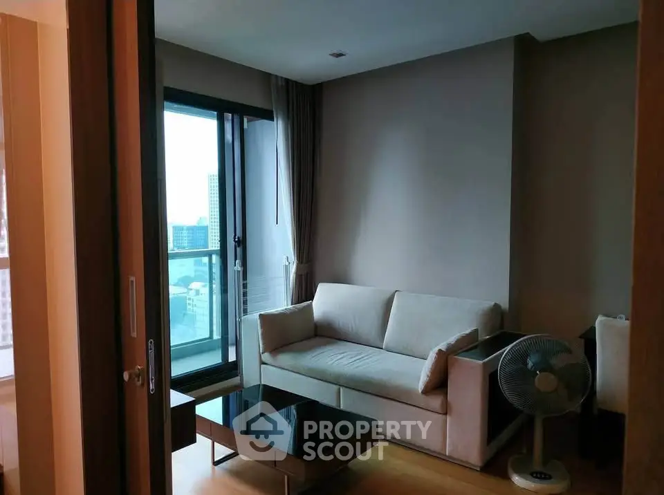 Cozy living room with modern sofa and city view balcony in urban apartment