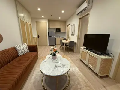 Modern living room with stylish furniture and open kitchen layout