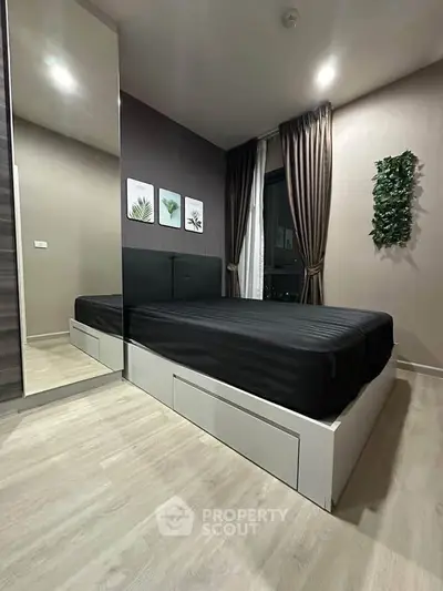 Modern bedroom with sleek design, featuring a mirrored wardrobe and stylish decor.
