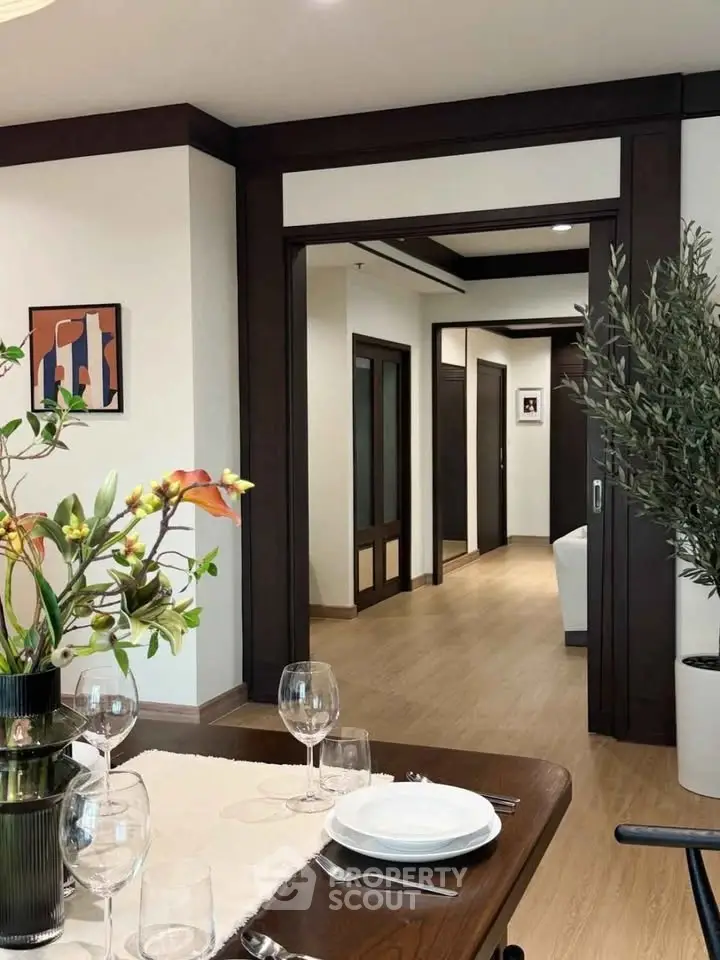 Elegant dining area with modern decor and wooden flooring in a stylish apartment.