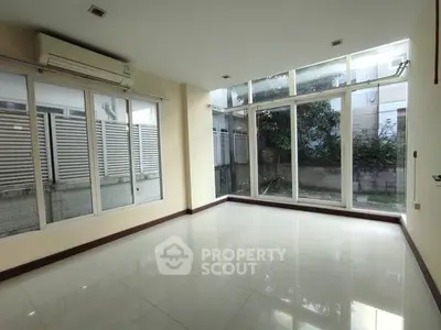 Spacious room with large windows and garden view, perfect for natural light lovers.