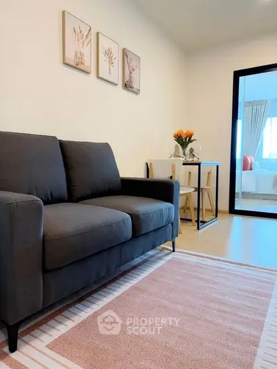 Modern living room with stylish sofa and elegant decor in a cozy apartment setting.