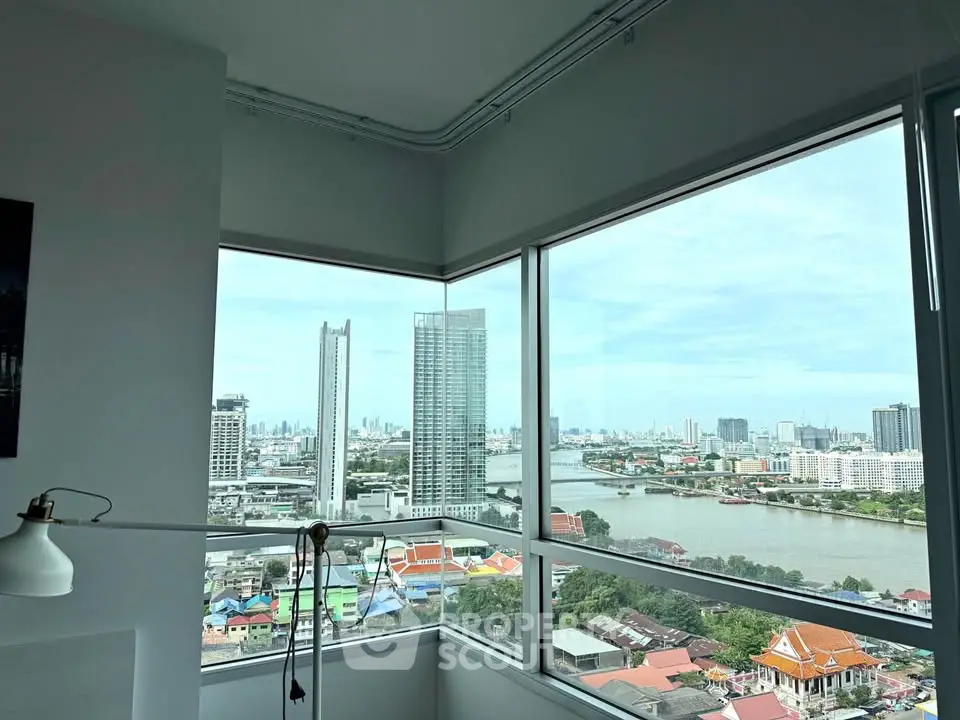 Stunning high-rise corner unit with panoramic city and river views.