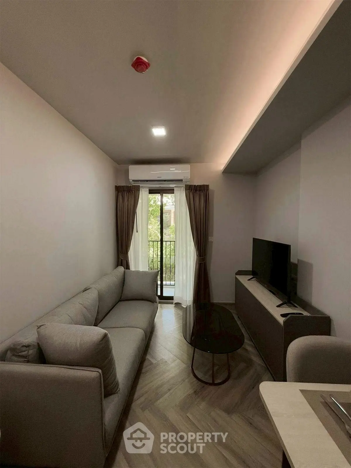 Modern living room with cozy sofa and balcony view