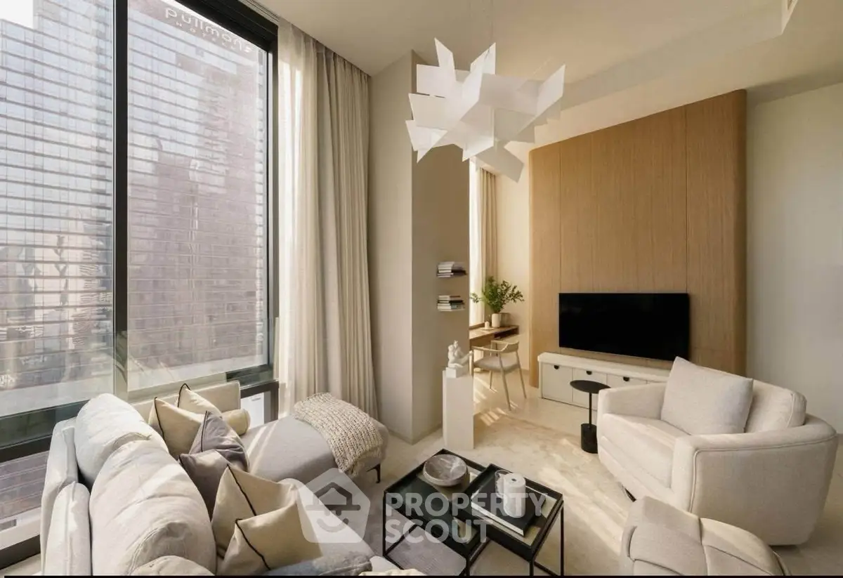 Modern living room with stylish furniture and large windows offering city views.