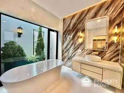 Luxurious modern bathroom with freestanding bathtub and elegant marble wall design