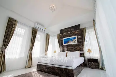 Luxurious bedroom with elegant decor and natural light, featuring a stylish bed and modern design.