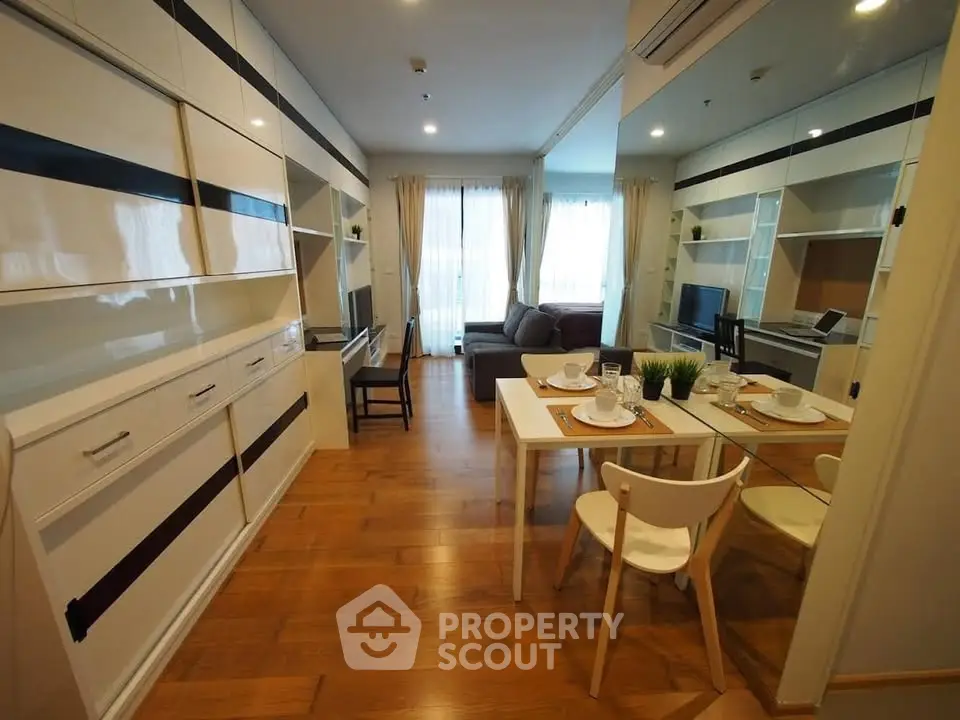 Modern living room with stylish decor and dining area in a cozy apartment.